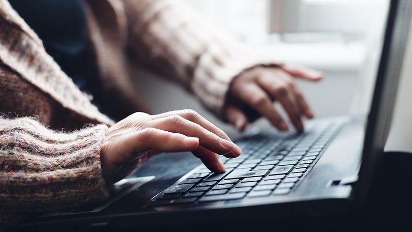 Image of woman typing on a laptop