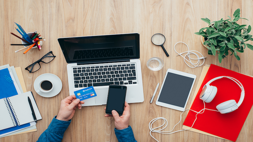 Image of person using phone to shop online.